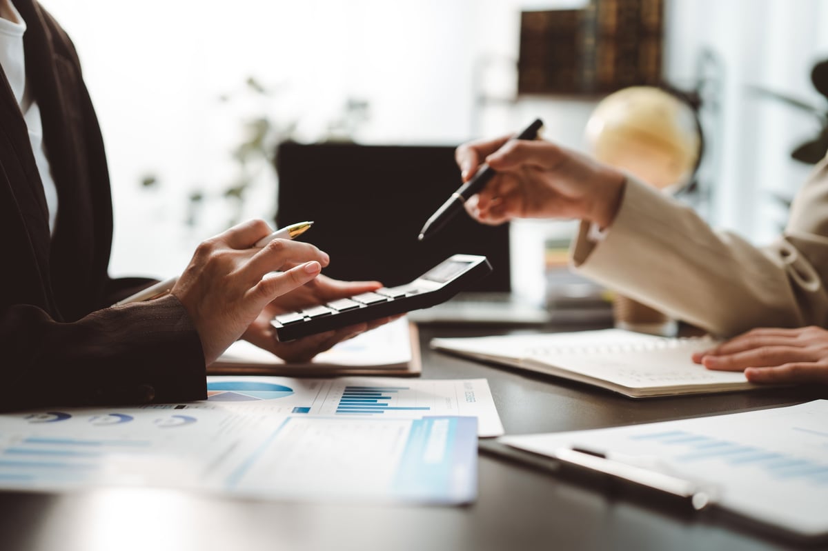 Diverse business professionals collaborating on financial documents